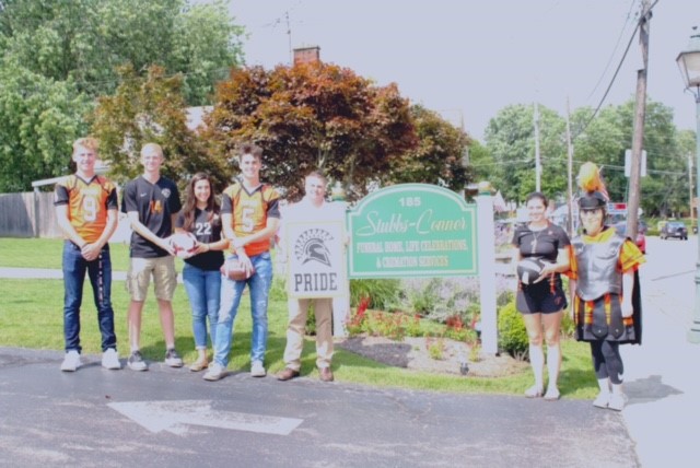 people wearing jerseys and holding sign